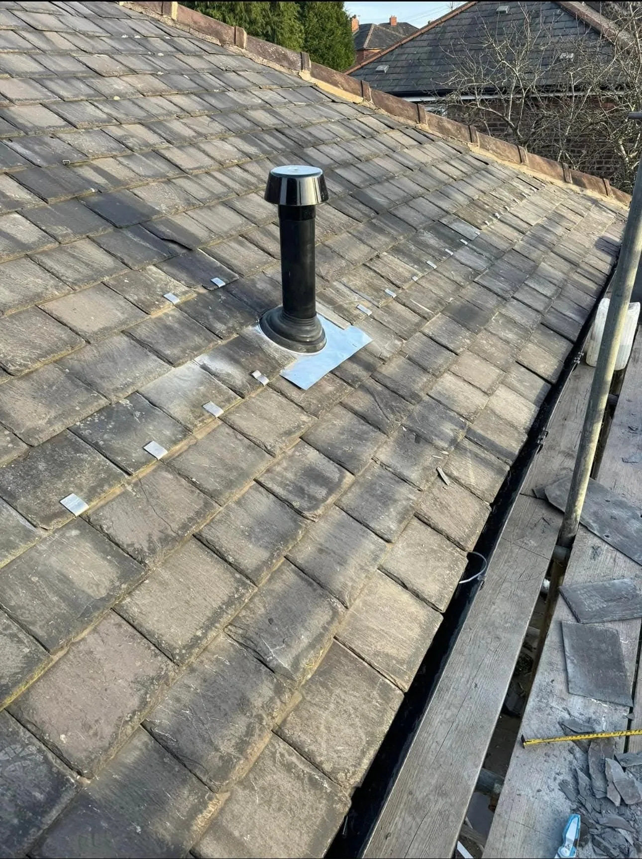 Emergency roof repair carried out on a slate roof to stop an active leak