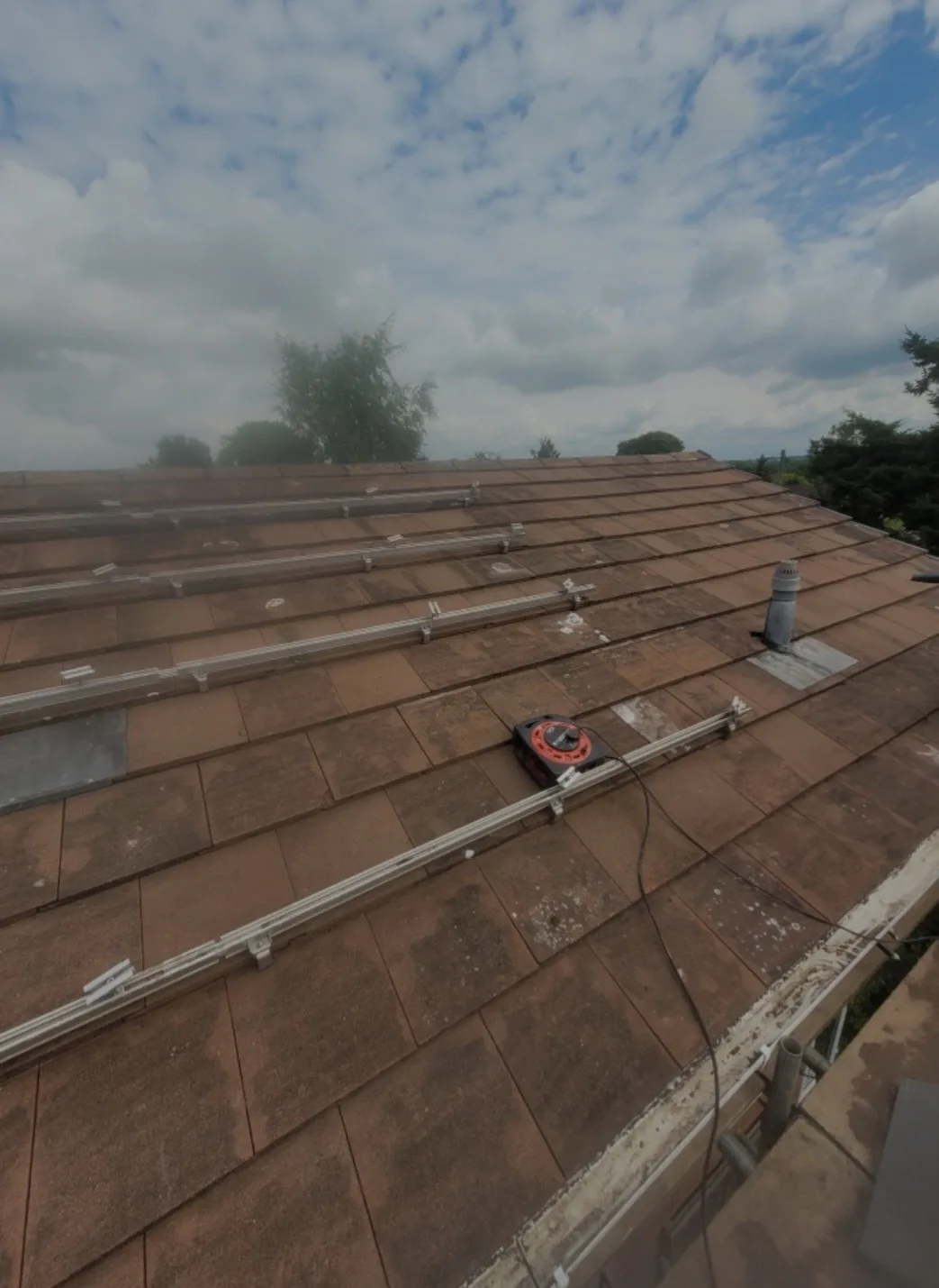 Solar panel mounting brackets fitted to a tiled roof