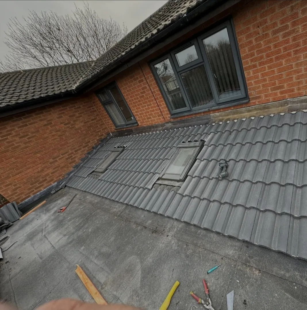 Newly installed Velux roof windows fitted into a grey tiled roof