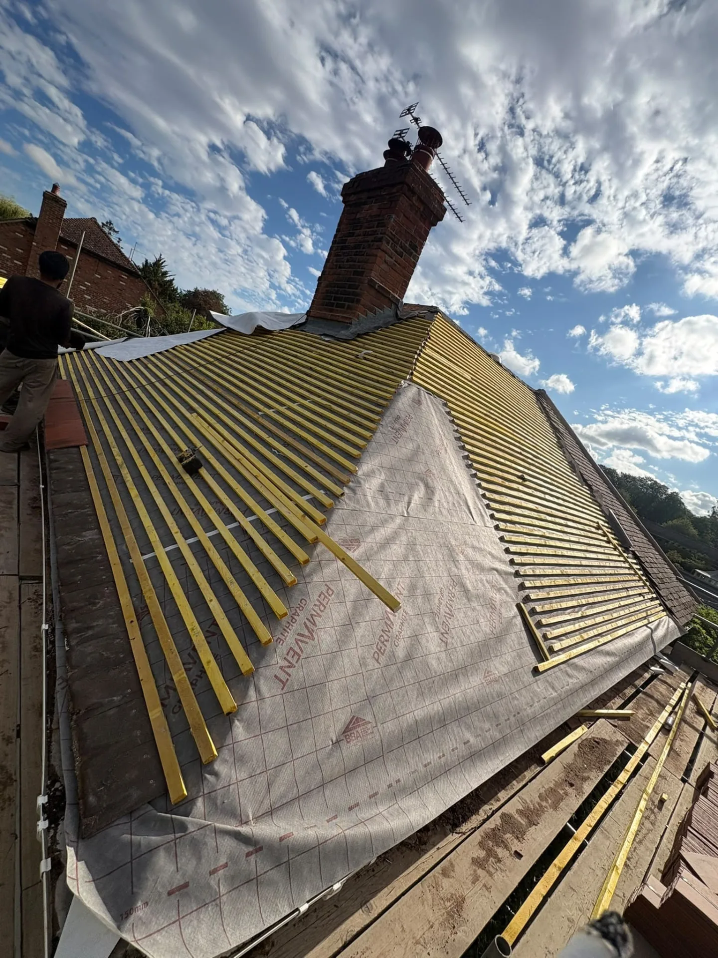 Felt and batten replacement in progress with new underlay and battens across a pitched roof
