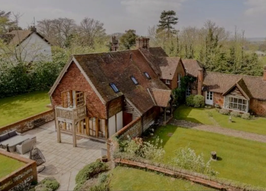 Elevated inspection view of a large residential property with multiple tiled roof sections